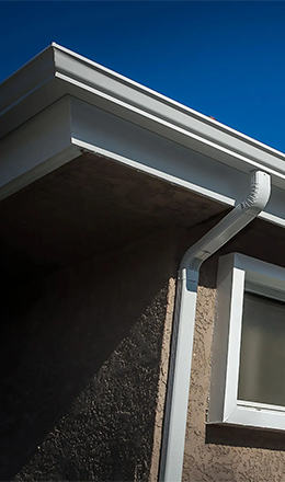 Traditional white OG rain gutters with downspouts